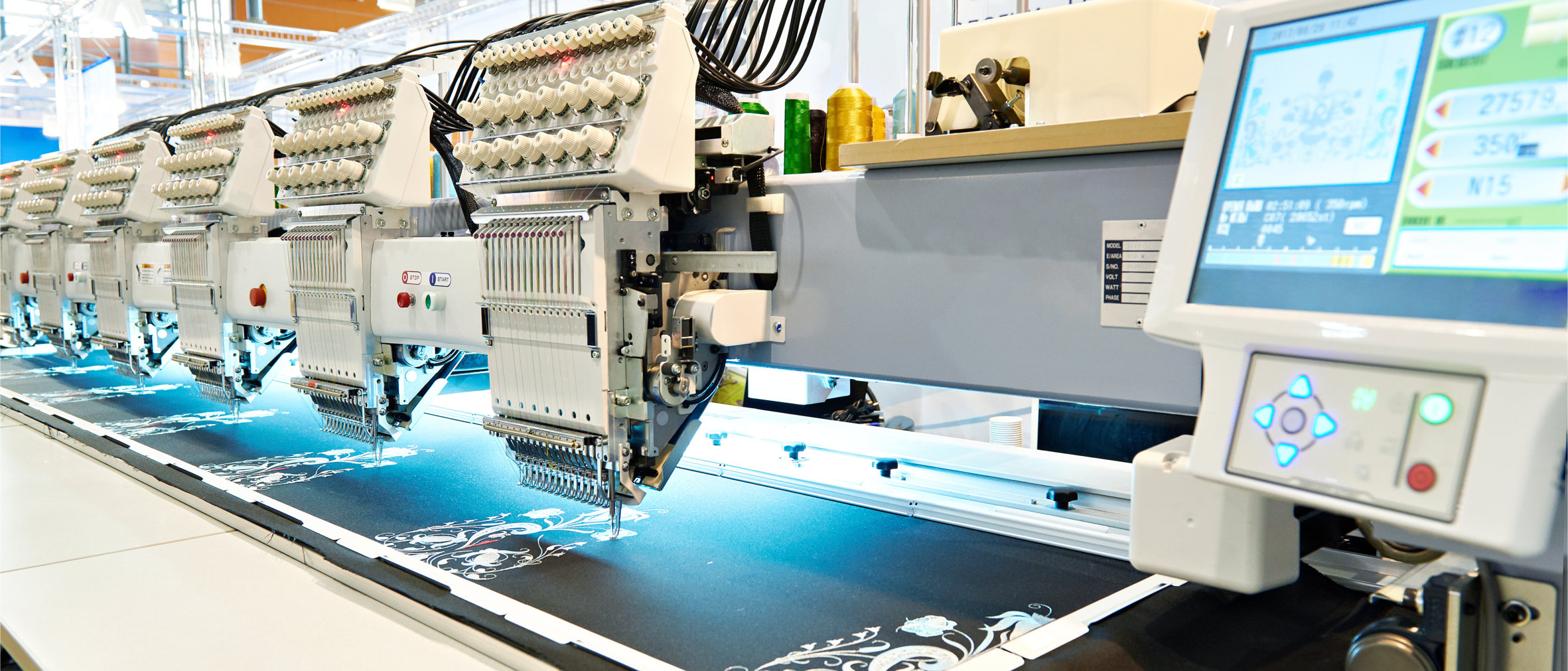 Embroidery machines stitching a design onto fabric